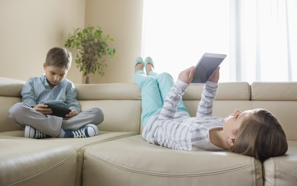 Children lying on couch with tablets for online safety for kids - Mykidstime