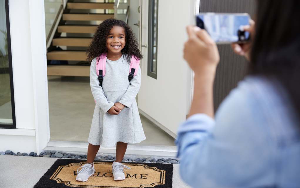 first day of school girl getting her photo taken