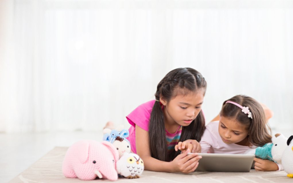 Girls playing on tablet apps for tweens