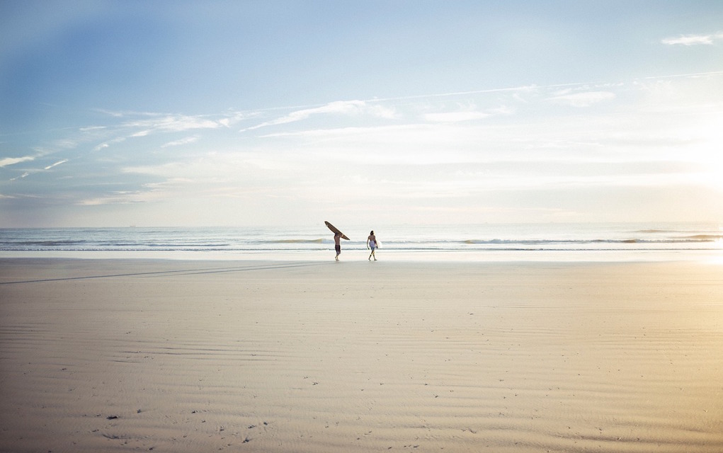 surfers on beach winter walks for families in Ireland